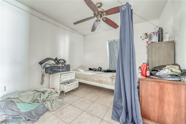 tiled bedroom featuring ceiling fan