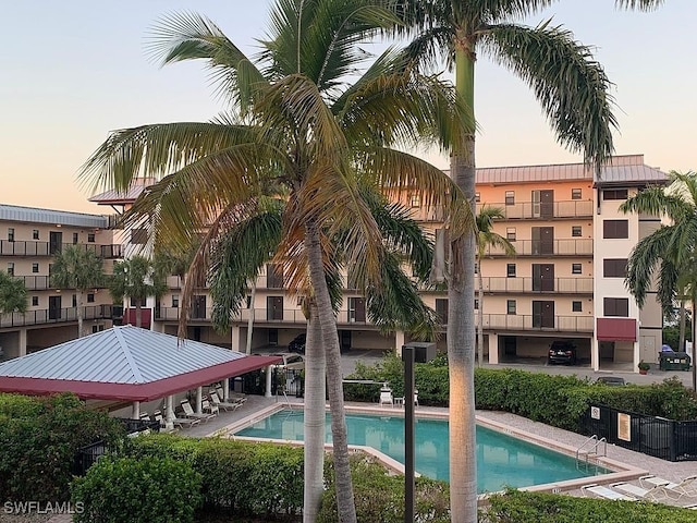 view of pool at dusk