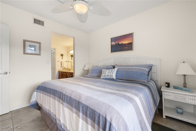 tiled bedroom with ceiling fan and ensuite bathroom