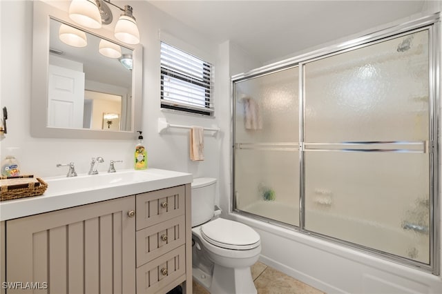 full bathroom featuring enclosed tub / shower combo, tile patterned flooring, vanity, and toilet