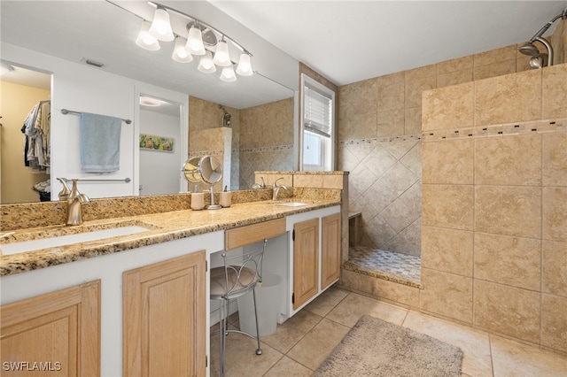 bathroom featuring tiled shower, vanity, and tile patterned floors