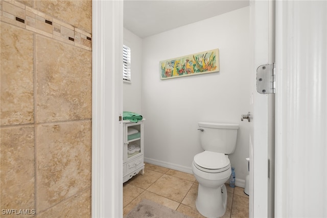 bathroom with toilet and tile patterned floors