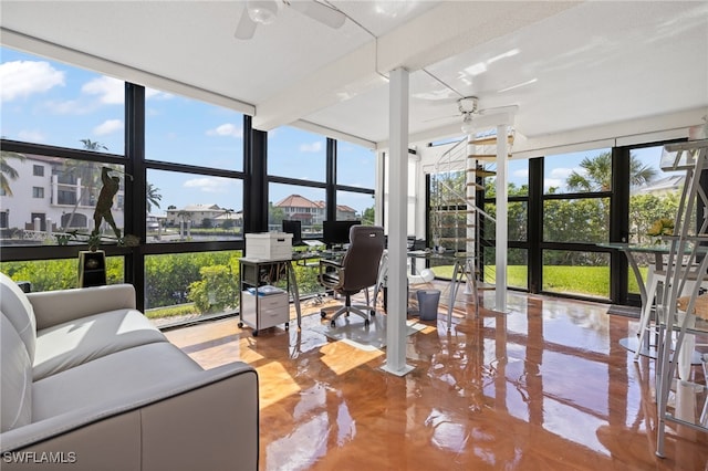 sunroom featuring ceiling fan and a healthy amount of sunlight