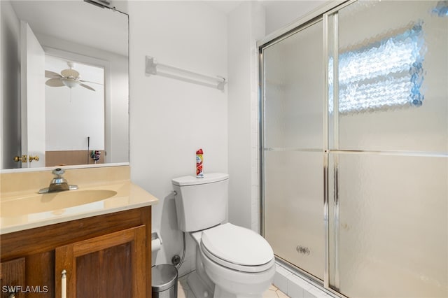 bathroom featuring tile patterned flooring, plenty of natural light, an enclosed shower, vanity, and toilet