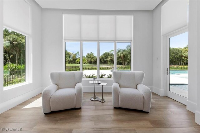 sitting room with a healthy amount of sunlight and light wood-style floors