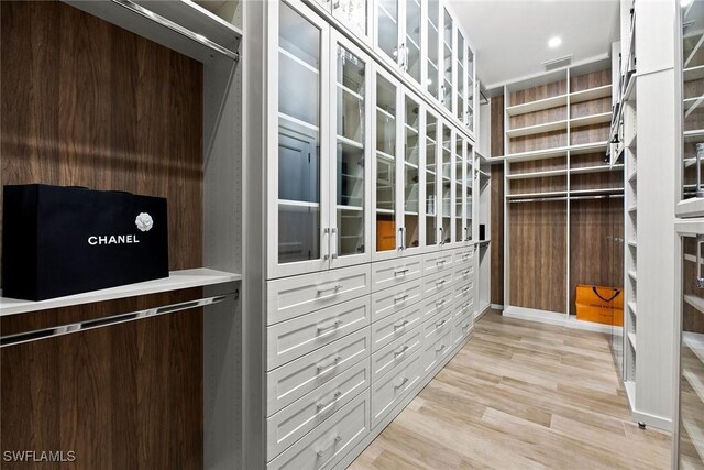 spacious closet featuring visible vents and light wood finished floors