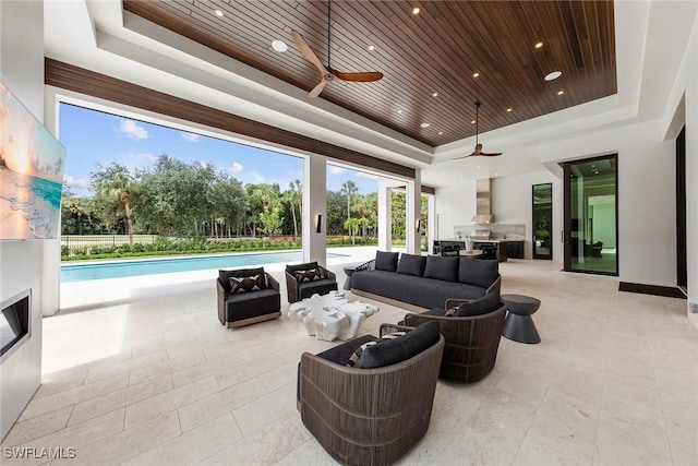 interior space featuring a tray ceiling, wooden ceiling, ceiling fan, and recessed lighting