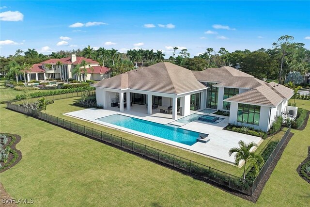 view of swimming pool featuring a patio, a fenced backyard, an in ground hot tub, a lawn, and a fenced in pool