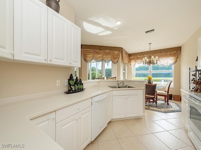 kitchen with sink, decorative light fixtures, a chandelier, white cabinetry, and dishwasher