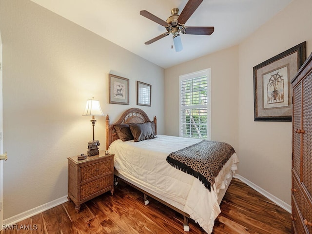 bedroom with dark hardwood / wood-style flooring and ceiling fan