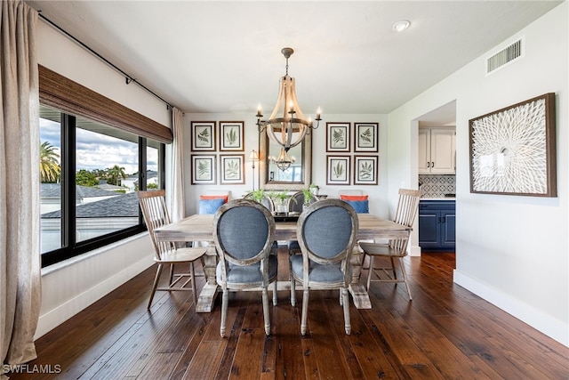 dining room featuring a chandelier and dark hardwood / wood-style flooring