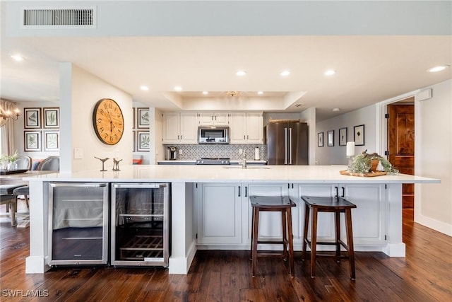 kitchen featuring stainless steel appliances, wine cooler, and a spacious island