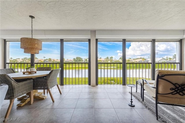 sunroom / solarium with plenty of natural light and a water view