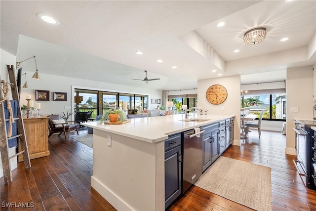 kitchen with appliances with stainless steel finishes, a wealth of natural light, ceiling fan, dark wood-type flooring, and sink