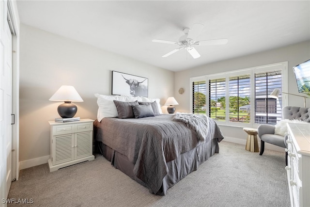 bedroom featuring light carpet and ceiling fan