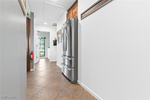 corridor featuring light tile patterned floors