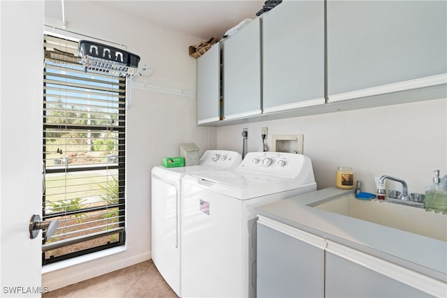 laundry area featuring cabinets, light tile patterned flooring, sink, and washing machine and dryer