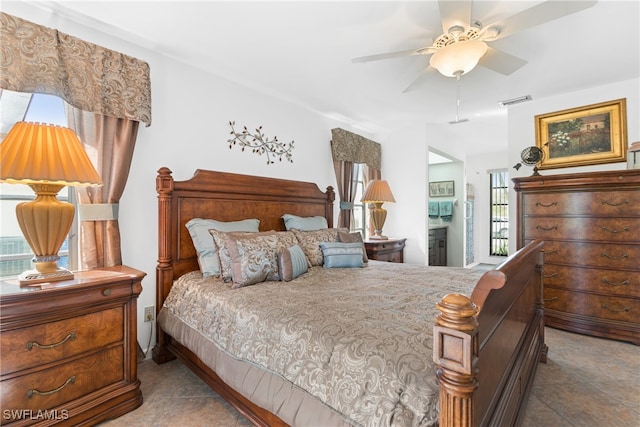 bedroom featuring ceiling fan, multiple windows, and light tile patterned floors