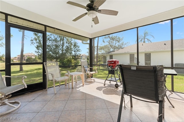 sunroom / solarium featuring ceiling fan