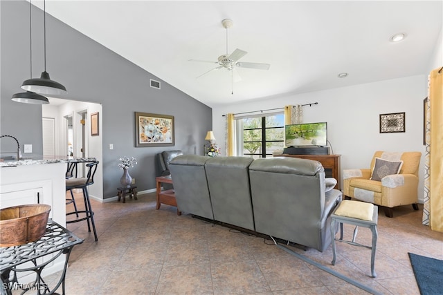 tiled living room featuring ceiling fan, high vaulted ceiling, and sink