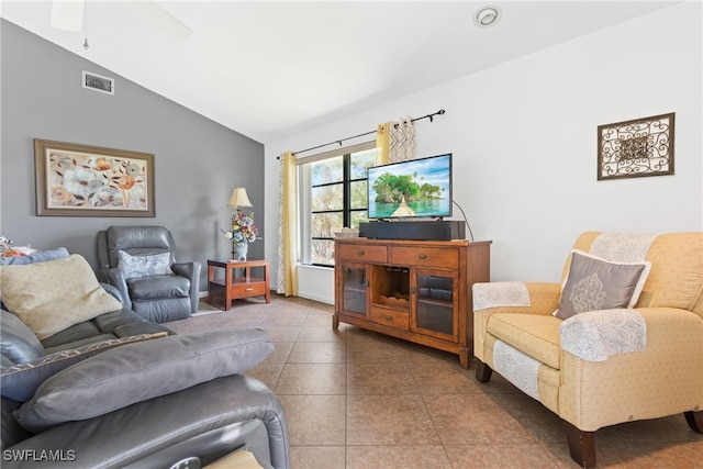 tiled living room featuring ceiling fan and vaulted ceiling