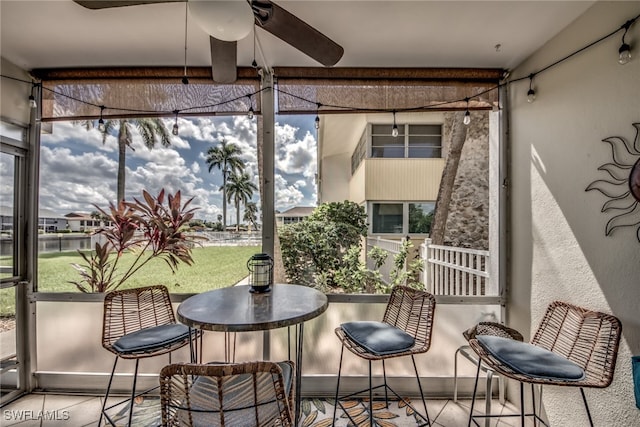 sunroom featuring ceiling fan