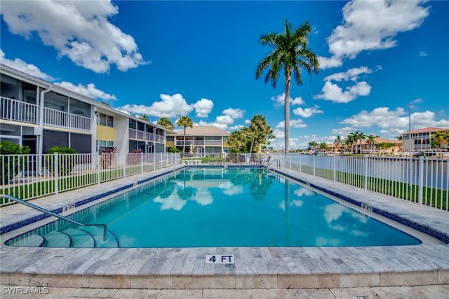 view of swimming pool with a water view