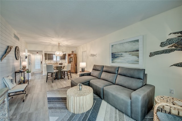 living room with a notable chandelier and hardwood / wood-style flooring