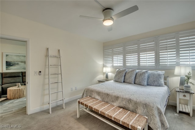 bedroom with ceiling fan and light colored carpet