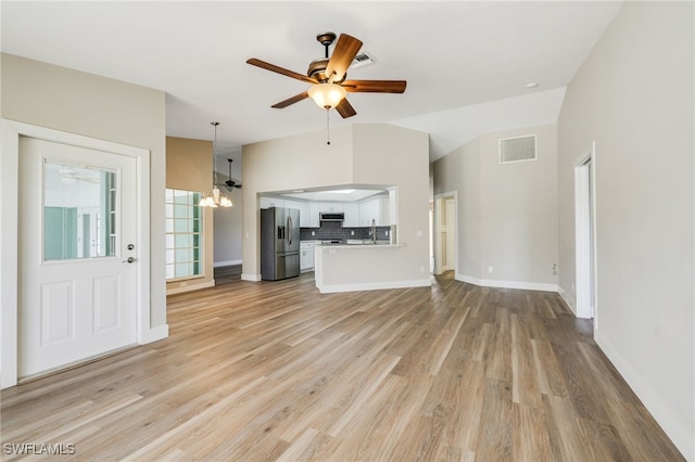 17585 Blackfriar Dr, Fort Myers, FL 33908 - unfurnished living room with light hardwood / wood-style floors, lofted ceiling, and ceiling fan with notable chandelier