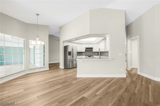 17585 Blackfriar Dr, Fort Myers, FL 33908 - kitchen featuring kitchen peninsula, white cabinetry, stainless steel appliances, and light wood-type flooring