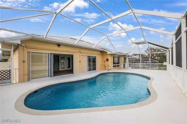 view of pool featuring a patio and glass enclosure