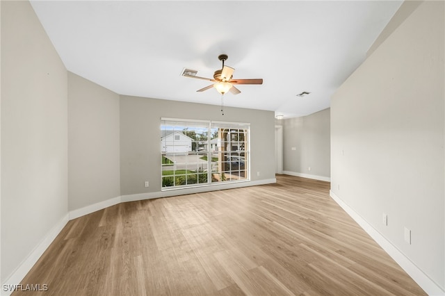 spare room featuring light wood-type flooring and ceiling fan