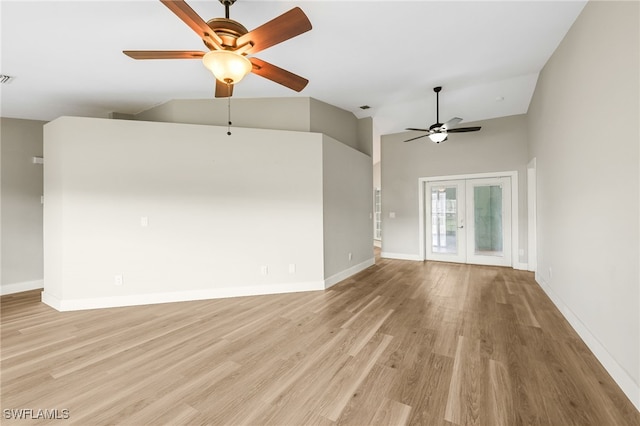 unfurnished living room featuring light hardwood / wood-style floors, french doors, high vaulted ceiling, and ceiling fan