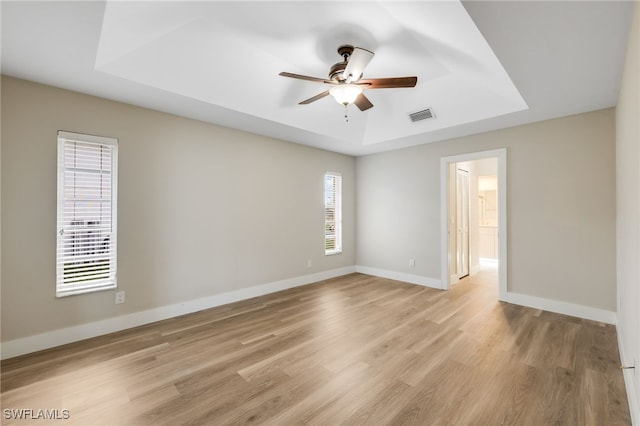 17585 Blackfriar Dr, Fort Myers, FL 33908 - spare room with a tray ceiling, light wood-type flooring, and ceiling fan
