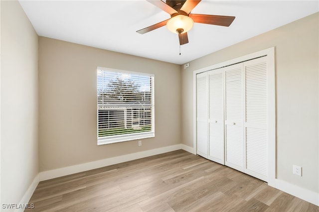 unfurnished bedroom with light hardwood / wood-style flooring, a closet, and ceiling fan