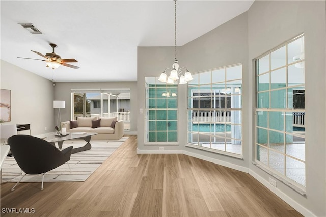 17585 Blackfriar Dr, Fort Myers, FL 33908 - dining area with wood-type flooring and ceiling fan with notable chandelier