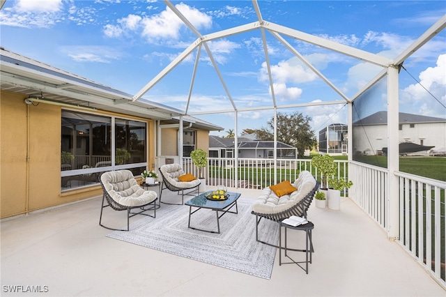 view of patio featuring glass enclosure