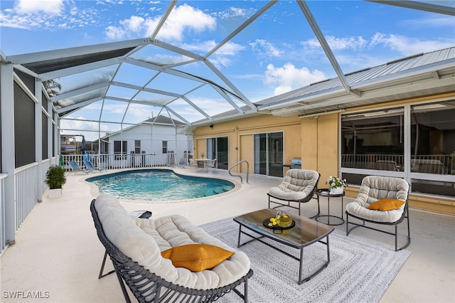 view of pool with a patio and a lanai