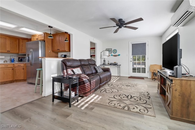 living room featuring light hardwood / wood-style flooring, ceiling fan, and a wall mounted air conditioner