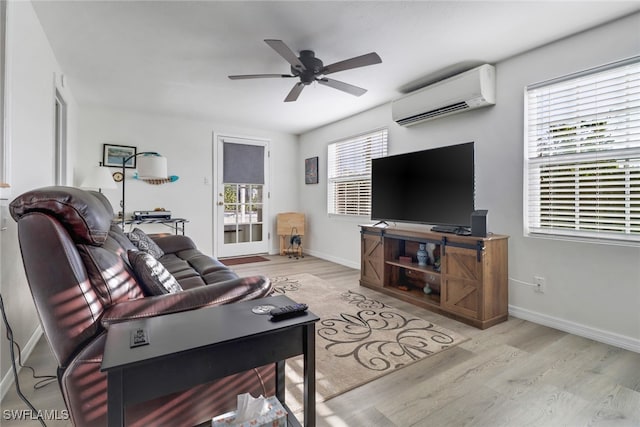 living room with light hardwood / wood-style floors, ceiling fan, plenty of natural light, and a wall mounted air conditioner