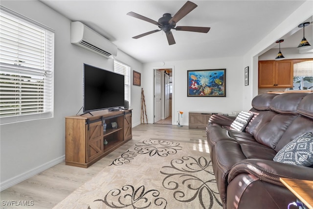 living room featuring light hardwood / wood-style floors, plenty of natural light, ceiling fan, and a wall mounted AC