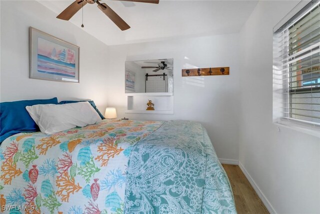 bedroom with wood-type flooring and ceiling fan