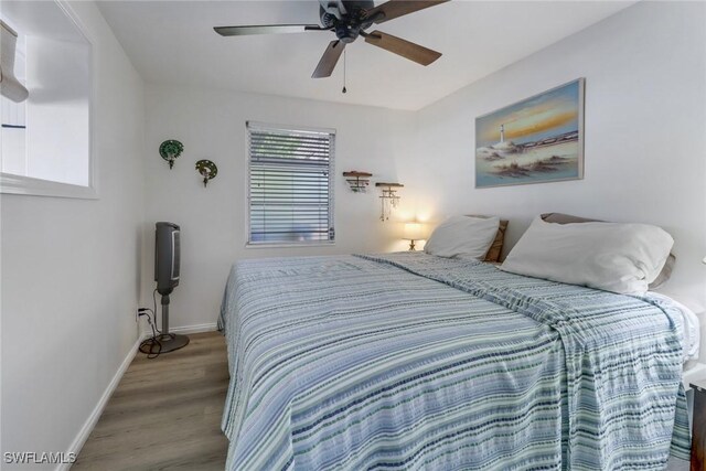 bedroom with hardwood / wood-style floors and ceiling fan