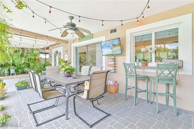 sunroom / solarium with ceiling fan and a healthy amount of sunlight