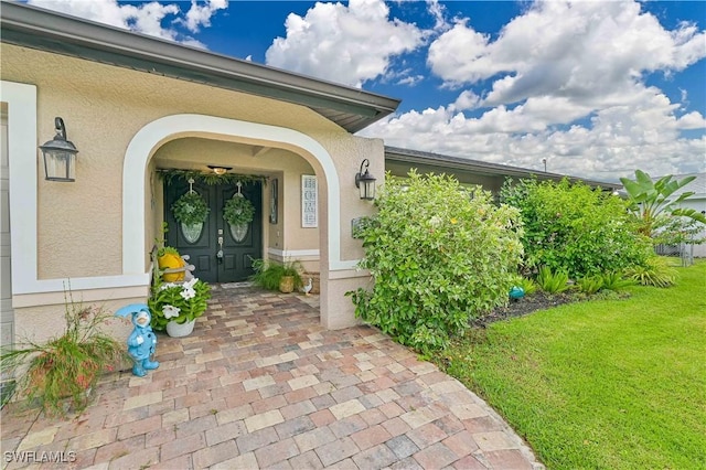 entrance to property with a yard