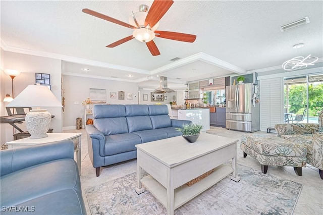 living room with ceiling fan, light tile patterned floors, crown molding, and a textured ceiling