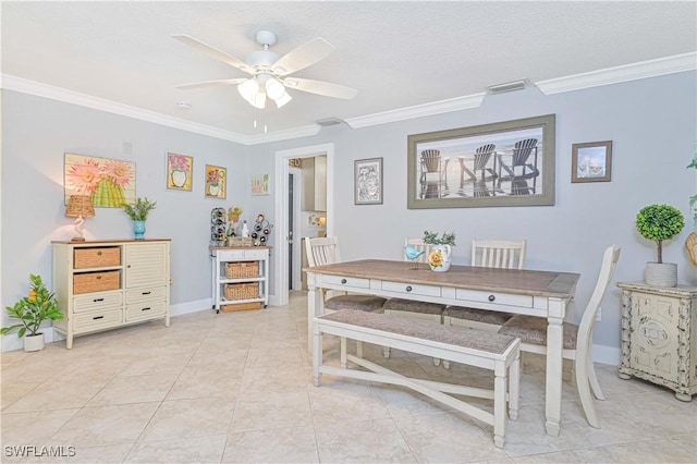 dining room featuring ceiling fan, light tile patterned floors, ornamental molding, and a textured ceiling