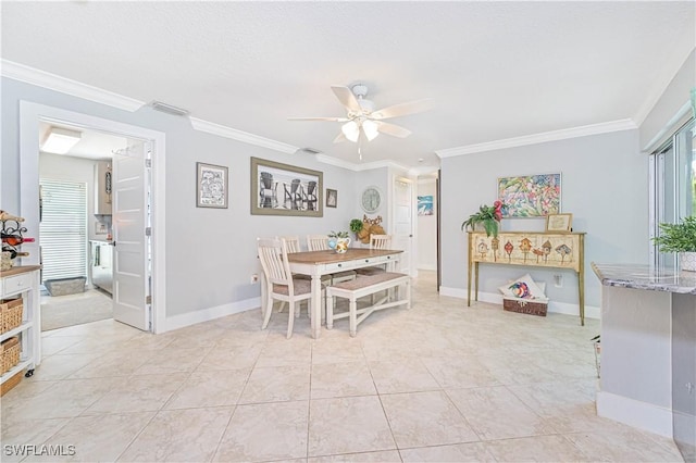 tiled dining area with ceiling fan and crown molding