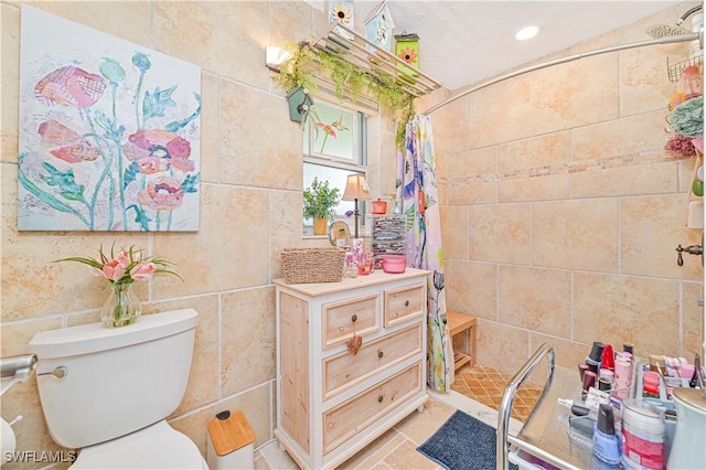 bathroom with toilet, a shower with curtain, and tile patterned flooring